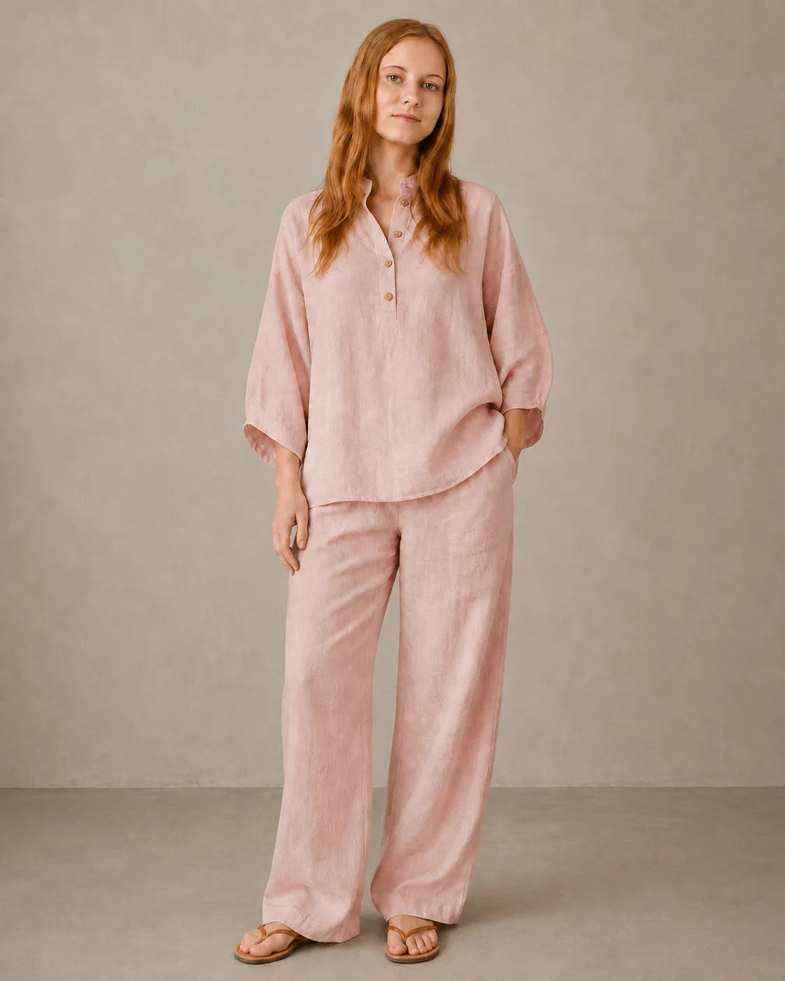 A model wears the cotton-linen co-ord set in lotus pink, styled with a long-sleeve collared shirt and matching trousers.