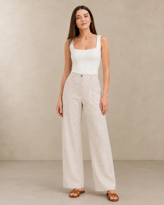 Close-up front view of natural linen wide-leg trousers with patch pockets, showing the fabric's natural texture.