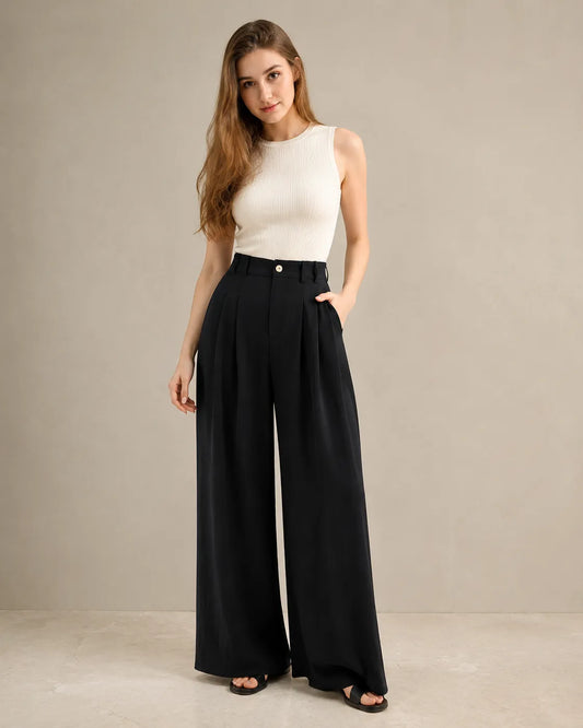 Model wearing black wide-leg tencel-linen trousers with an ivory ribbed tank top, a classic black and off-white two-colour combination, front view.