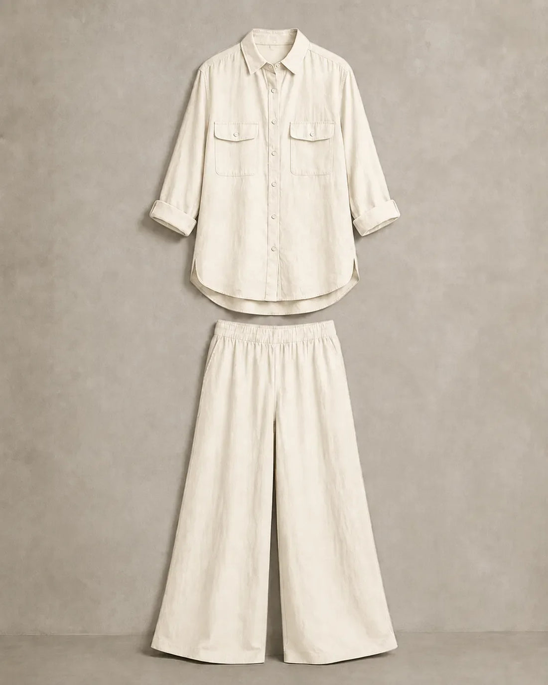 The beige-and-white linen co-ord set laid out flat, with the button-down shirt and wide-leg trousers shown as separate pieces that can be worn together or apart.
