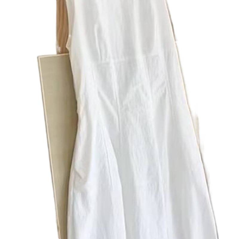 A woman wearing a waist-baring dress