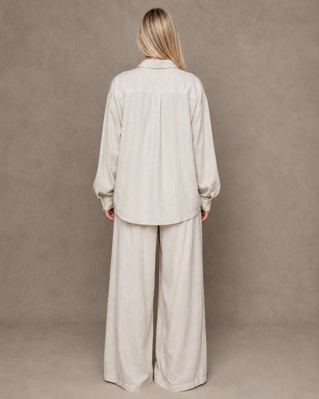 Back view of a beige linen shirt with a polo collar and long sleeves.