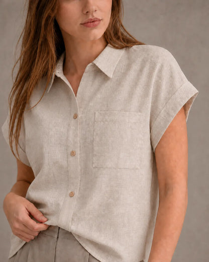 Close-up of the chest pocket and collar on a natural undyed linen shirt.