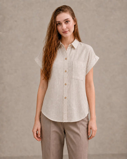 Woman wearing a natural undyed linen shirt with a polo collar and short sleeves, viewed from the front.
