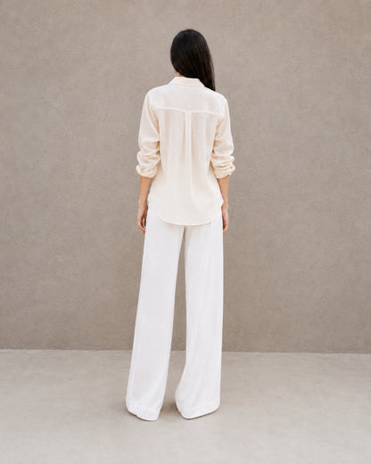 Back view of a off-white lyocell-linen cardigan-style shirt with long sleeves.