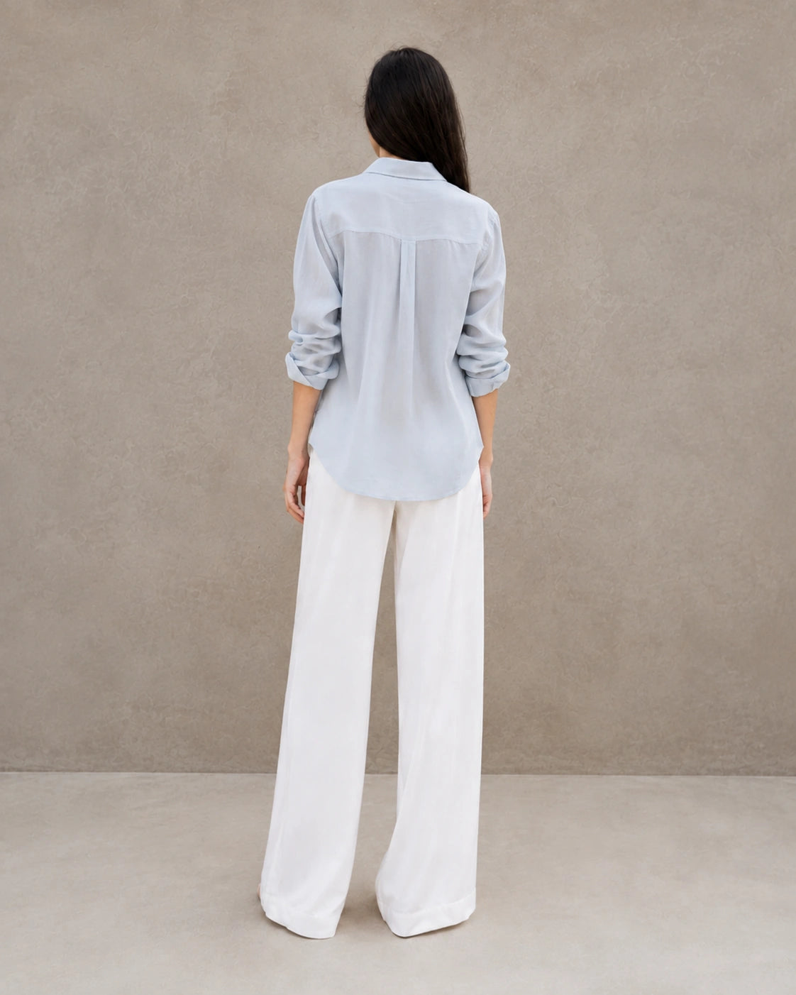 Back view of a grey-blue lyocell-linen cardigan-style shirt with long sleeves.