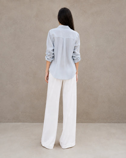Back view of a grey-blue lyocell-linen cardigan-style shirt with long sleeves.