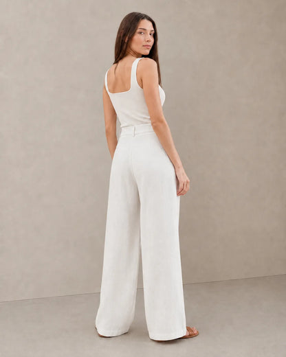 Back view of model wearing white wide-leg summer trousers in a cotton-linen-polyester blend.
