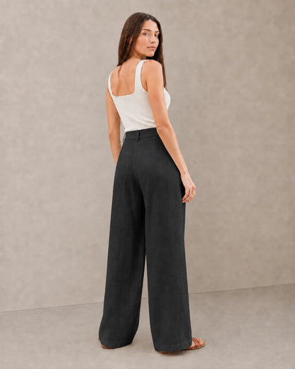 Back view of model wearing black wide-leg summer trousers in a cotton-linen-polyester blend.