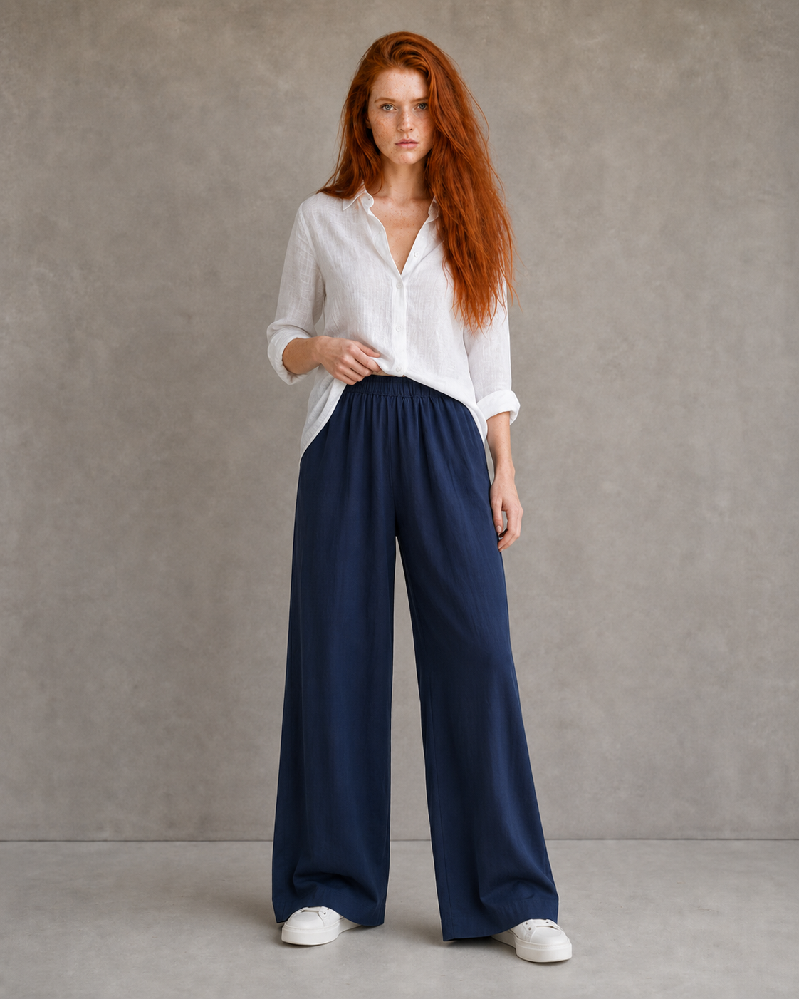 Model wearing burgundy wide-leg linen-cotton trousers with an elasticated drawstring waist, front view.