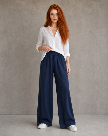 Model wearing burgundy wide-leg linen-cotton trousers with an elasticated drawstring waist, front view.