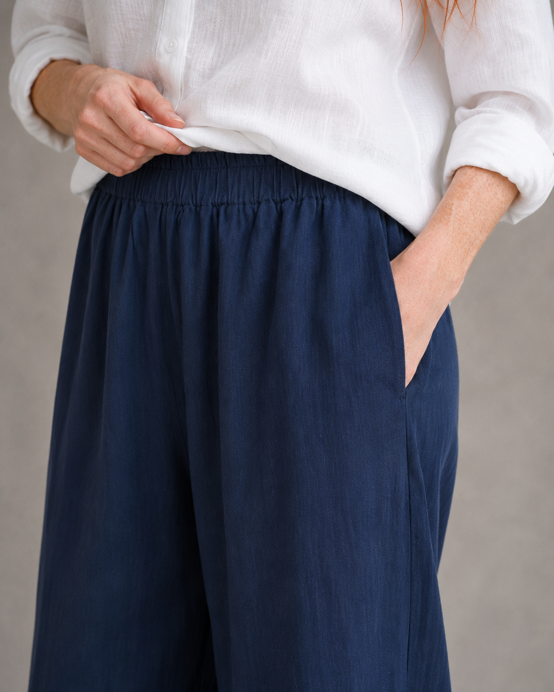 Close-up of the elasticated drawstring waist on burgundy wide-leg linen-cotton trousers.