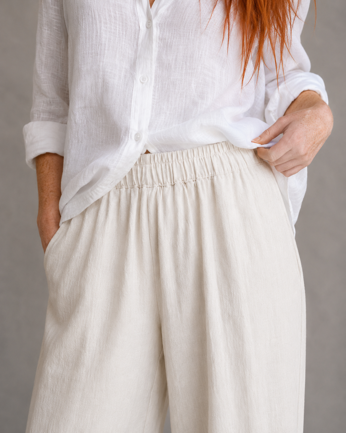 Close-up of the elasticated drawstring waist on orange wide-leg linen-cotton trousers.