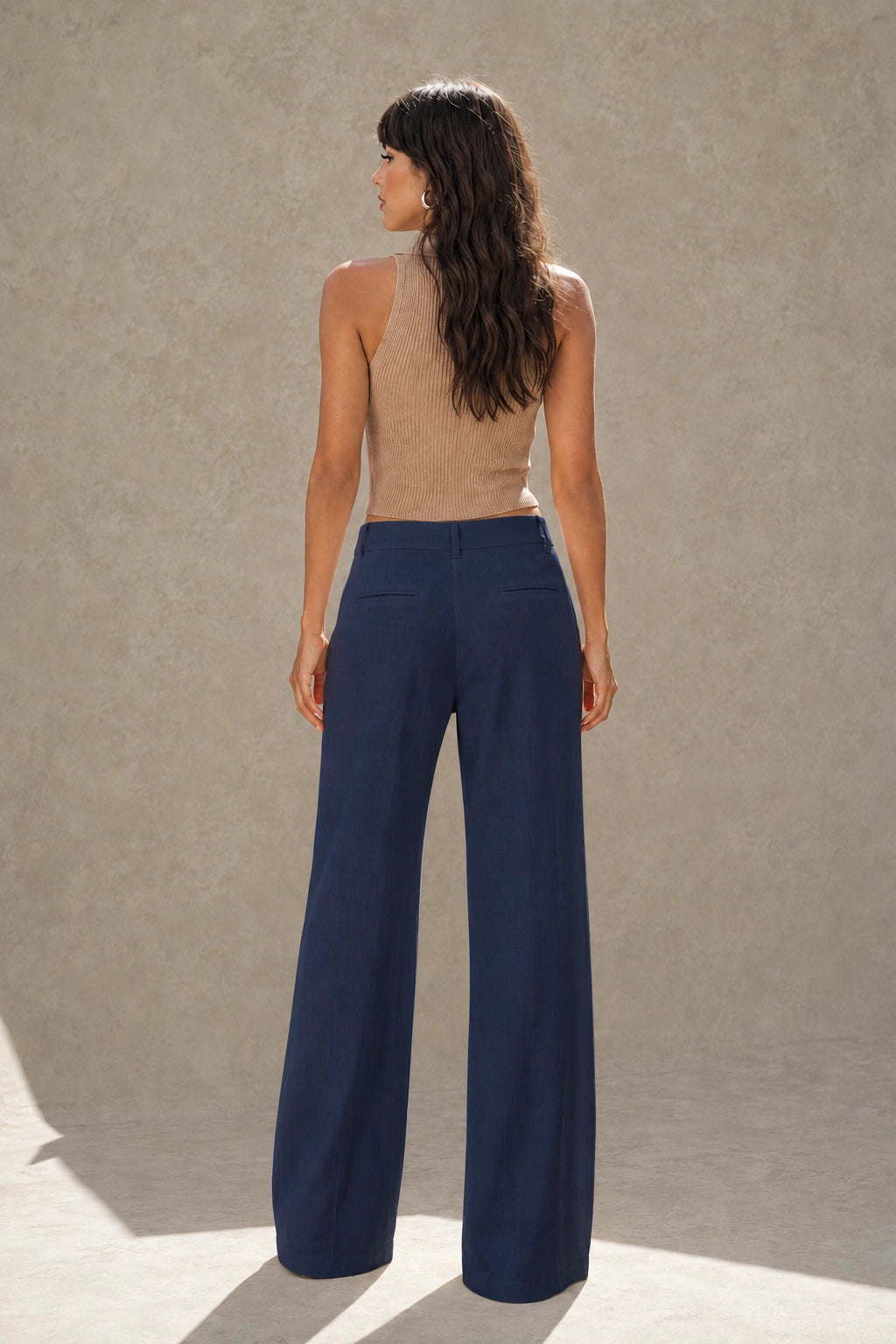 Navy Blue wide-leg linen-cotton trousers with a high waist, back view, styled shot.
