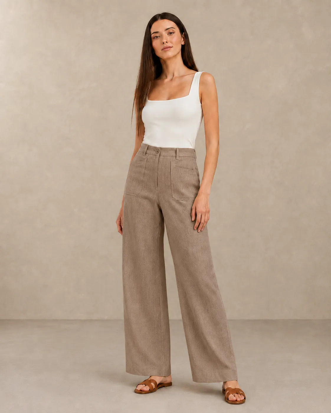 Close-up front view of model in latte-coloured linen wide-leg trousers with patch pockets, part of Sarolu extended size range.