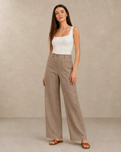 Close-up front view of model in latte-coloured linen wide-leg trousers with patch pockets, part of Sarolu extended size range.
