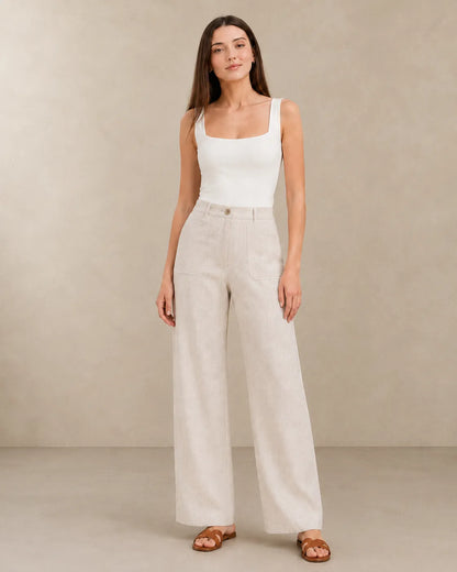 Close-up front view of model in natural linen wide-leg trousers with patch pockets, part of Sarolu extended size range.