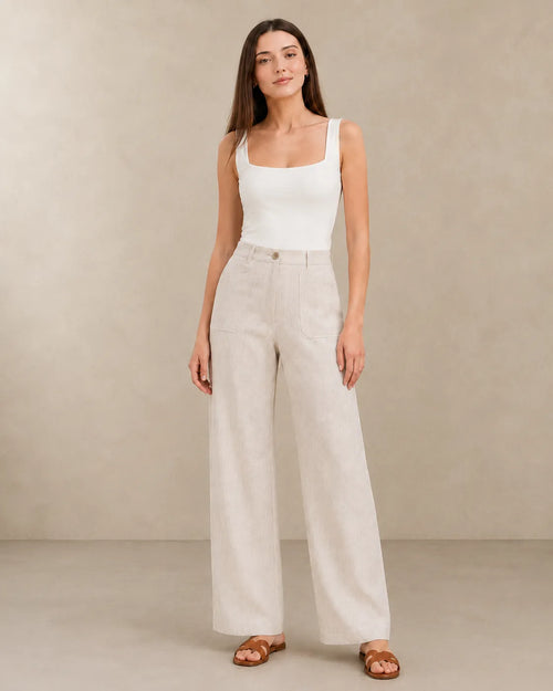 Close-up front view of model in natural linen wide-leg trousers with patch pockets, part of Sarolu extended size range.
