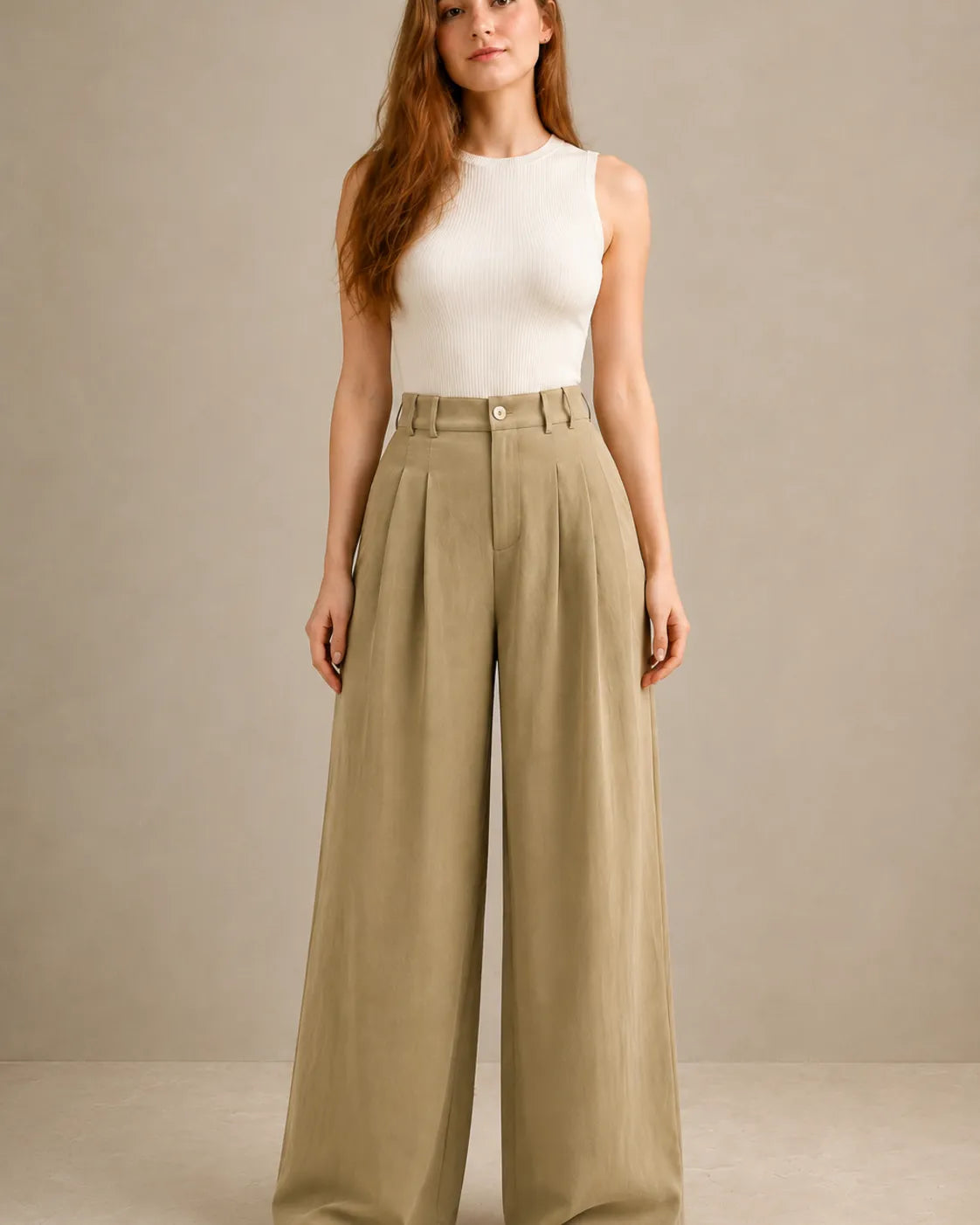 Close-up front view of model in black wide-leg trousers in a tencel-linen blend with a draped finish.