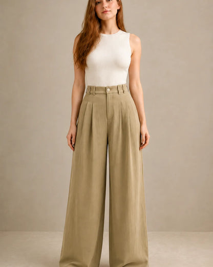 Close-up front view of model in black wide-leg trousers in a tencel-linen blend with a draped finish.