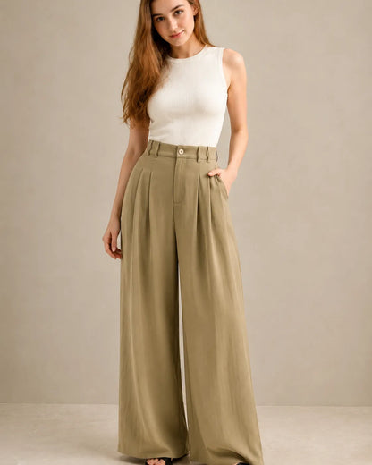 Model wearing black wide-leg trousers in a tencel-linen blend with a draped finish, cover shot.