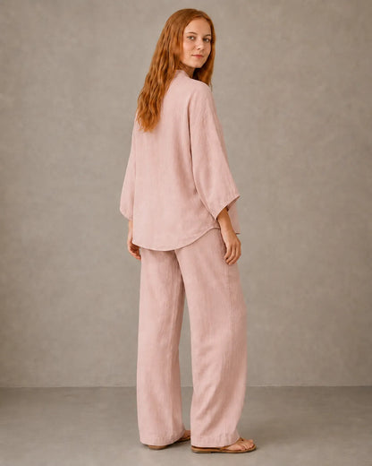 Back view of a model in the lotus pink cotton-linen co-ord set, showing the relaxed drape of the shirt over the trousers.