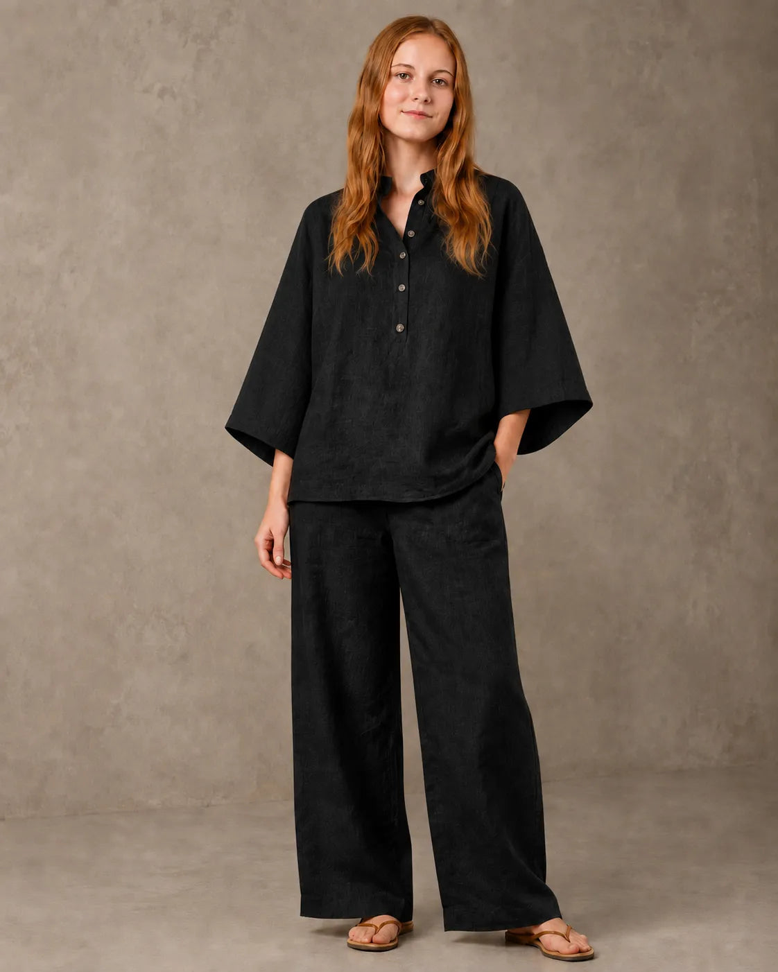 A closer front view of a model wearing the black cotton-linen co-ord set, showing the shirt's collar and button front.