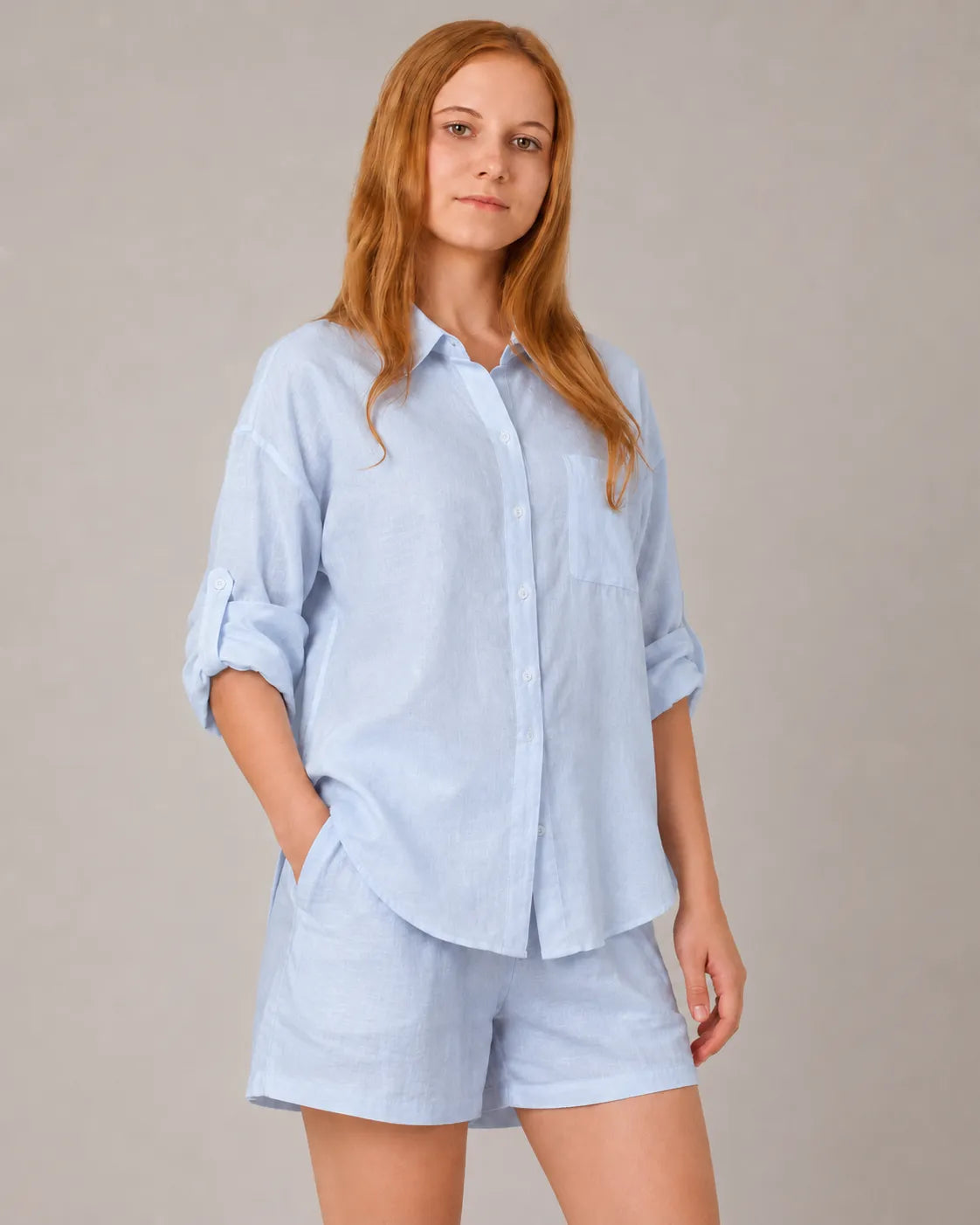 A closer front view of a model wearing the light blue linen-cotton co-ord set, showing the shirt's chest pocket and button front.