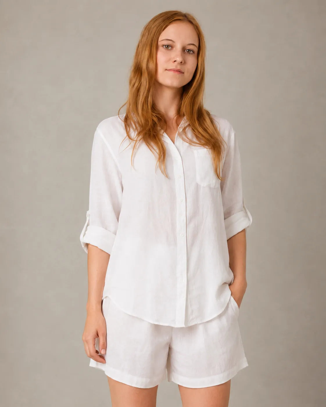 A closer front view of a model wearing the white linen-cotton co-ord set, showing the shirt's chest pocket and button front.