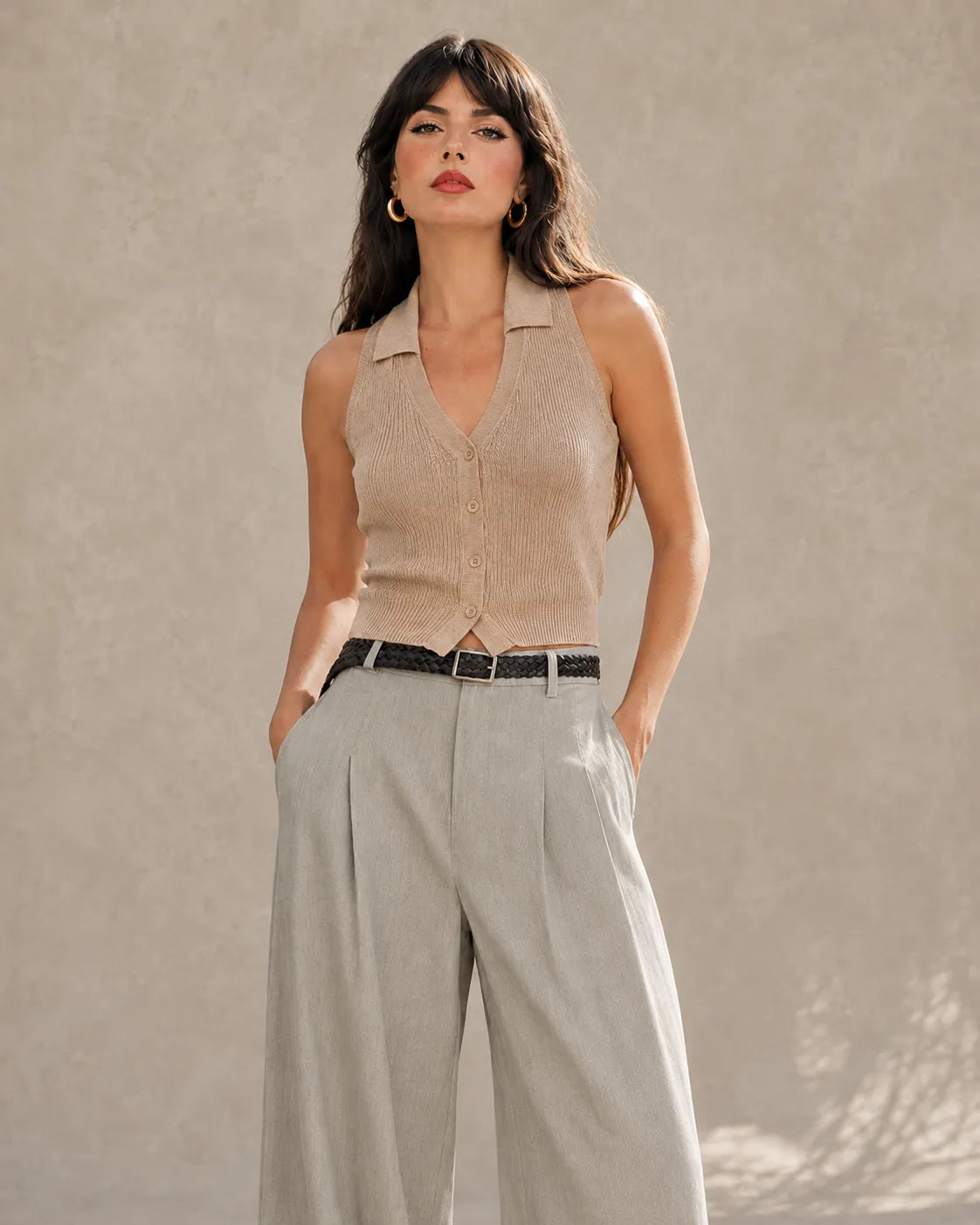 Close-up front view of a model wearing light gray tencel-linen wide-leg trousers, showing the high waist and belt.