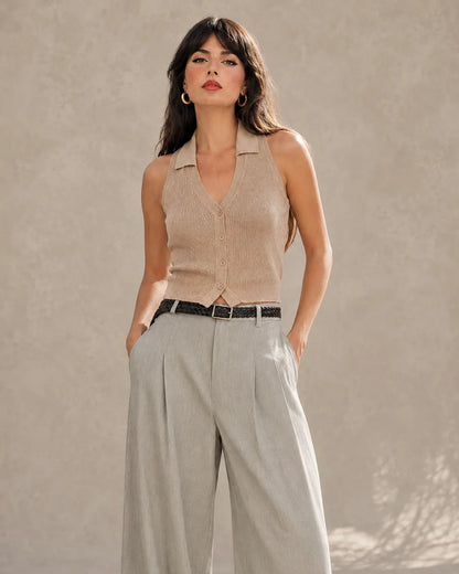 Close-up front view of a model wearing light gray tencel-linen wide-leg trousers, showing the high waist and belt.