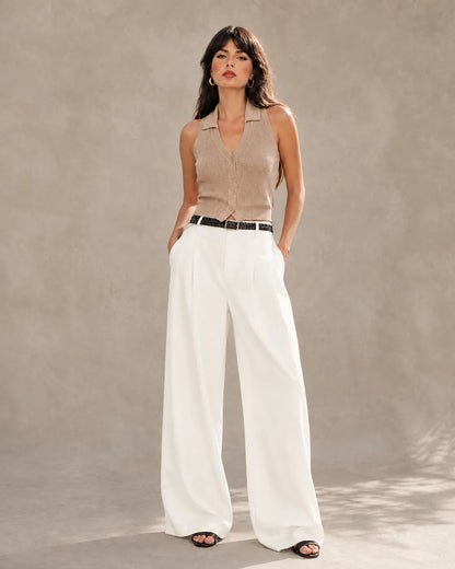 Woman wearing pearl white tencel-linen wide-leg trousers with a high waist and front pleats, shown from the front.