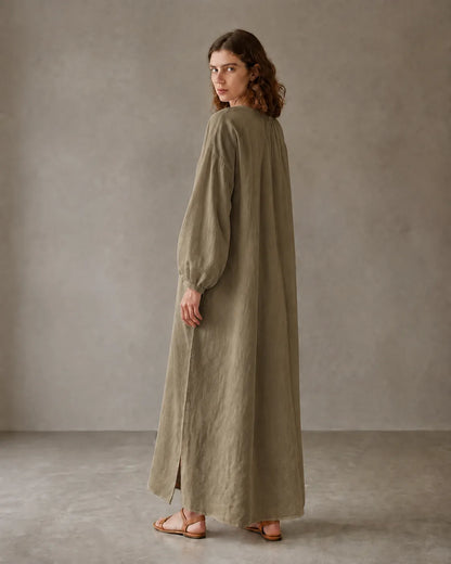Back view of a khaki cotton-linen dress with long sleeves and a side hem slit, shown on a model.