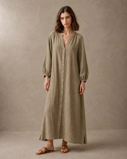 Woman wearing a khaki cotton-linen dress with a V-neckline, long balloon sleeves with elastic cuffs and a button placket, shown from the front.