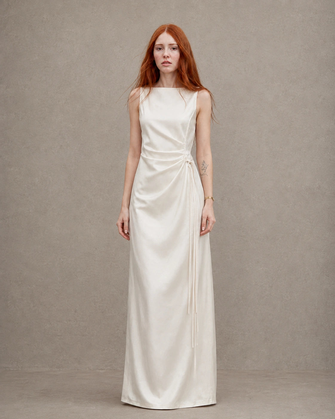 Woman wearing an apricot tencel-linen fitted dress with a high waist seam and side tie detail, shown from the front.