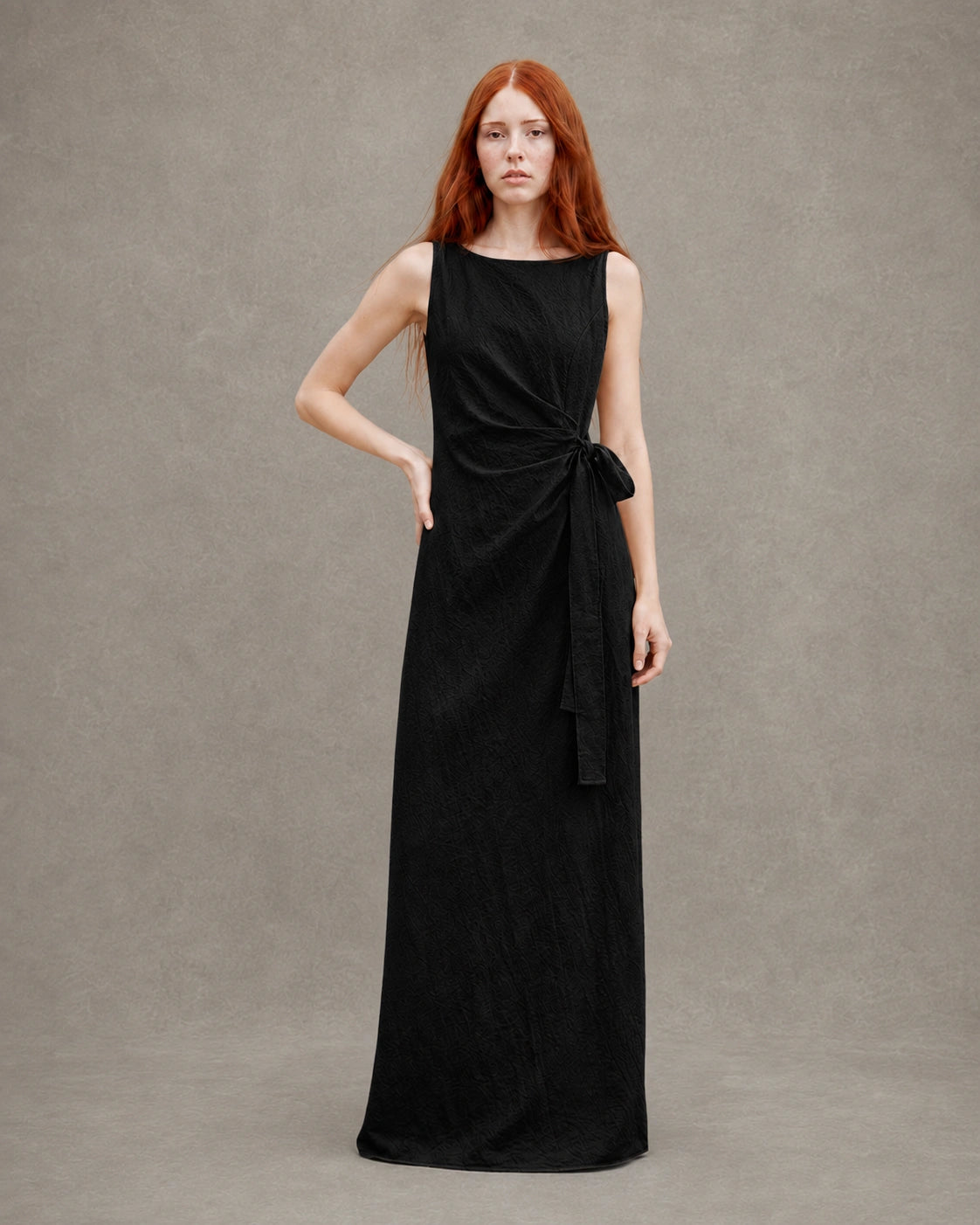 Back view of a black tencel-linen fitted dress with a fitted A-line skirt, shown on a model.