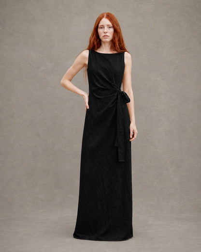 Back view of a black tencel-linen fitted dress with a fitted A-line skirt, shown on a model.